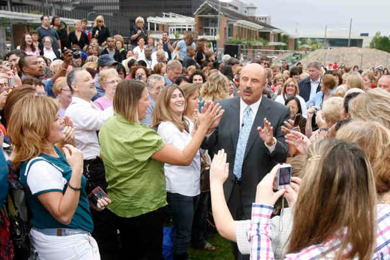 Dr. Phil makes his way through a crowd of fans on Independence Mall. He shot his one and only live show from Philadelphia yesterday and taped a second show to be seen tomorrow.