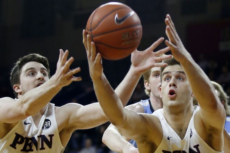 Penn forward Max Rothschild (right) and guard Jackson Donahue go after the basketball against Columbia guard Jake Killingsworth during the first-half on Friday, February 10, 2017.