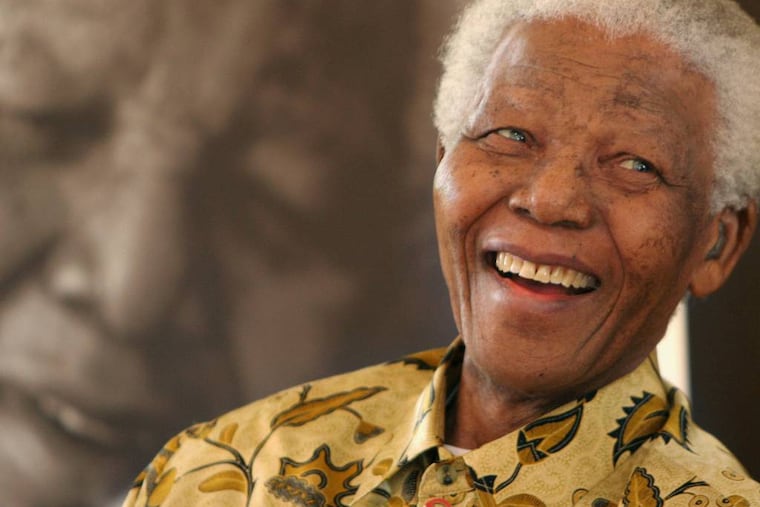 FILE - In this Dec. 7, 2005, file photo, former South African President Nelson Mandela, 87, is in a jovial mood at the Mandela Foundation in Johannesburg, where he met with the winner and runner-up of the local "Idols" competition. South Africa's president says, Thursday, Dec. 5, 2013, that Mandela has died. He was 95. (AP Photo/Denis Farrell, File)