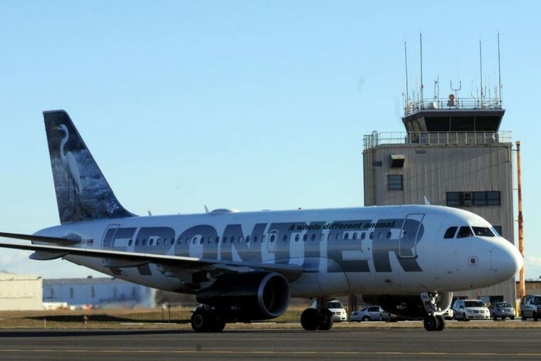 A Frontier Airlines jet taxis at Trenton-Mercer County Airport.