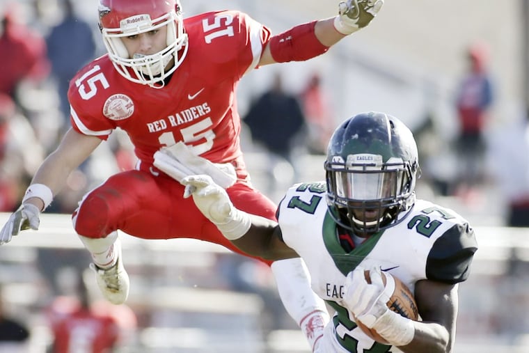 Paulsboro’s Gabe Onorato (15) pursues West Deptfod’s Tyshawn Bookman (27).