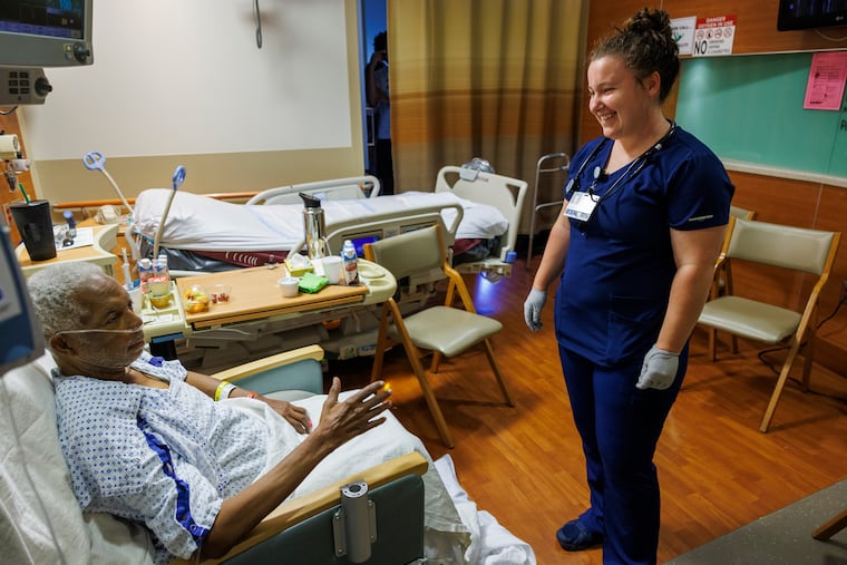 Donna Williams, registered nurse at Lankenau Medical Center, in Wynnewood, visits with patient Jeffrey Tate last month. Williams is one of 179 Lankenau nurses who received funds from an anonymous donation that helps them pay off their student loans.