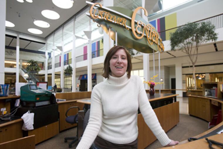 Melonie Messina, marking director at the Plymouth Meeting Mall, stands behind the customer service counter where a winning Powerball ticket was sold. The ticketholder has not yet come forward to claim the millions. (Ed Hille / Staff Photographer)