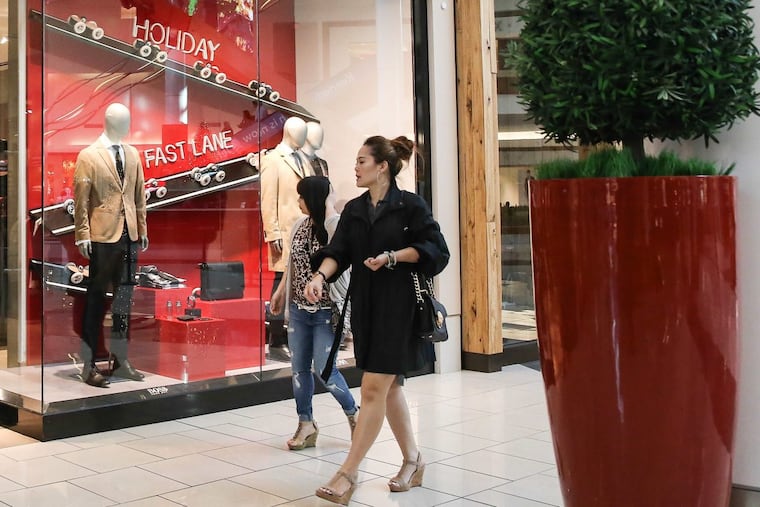 At Cherry Hill Mall, Hugo Boss is bathed in red and green for the start of this year’s holiday shopping season that kicks off on Black Friday.