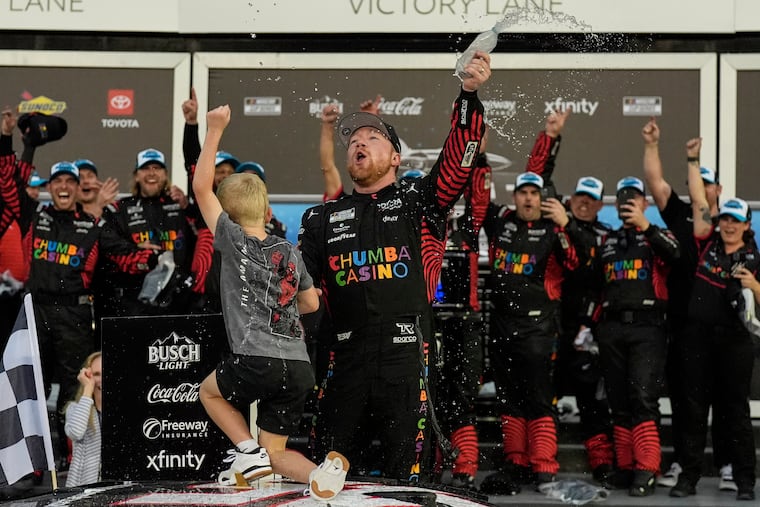 Tyler Reddick, (45) and his son Beau celebrate with the team after winning the NASCAR Daytona 500 auto race at Daytona International Speedway, Sunday, Feb. 15, 2026, in Daytona Beach, Fla. (AP Photo/Mike Stewart)