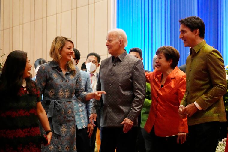 Flanked by Canada's Prime Minister Justin Trudeau, right, and International Monetary Fund Kristalina Georgieva, second right, U.S. President Joe Biden speaks with Canada's Foreign Minister Melanie Holy at the Association of Southeast Asian Nations (ASEAN) gala dinner, Saturday, Nov. 12, 2022, in Phnom Penh, Cambodia.