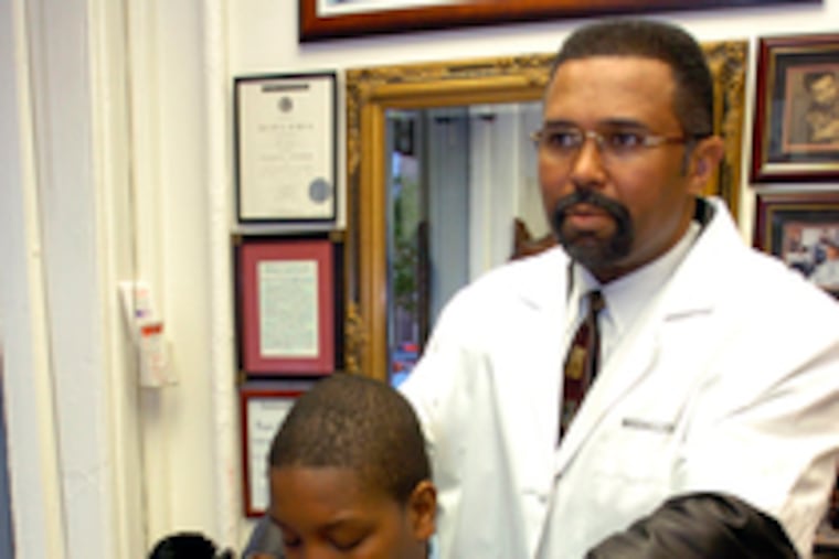 Arthur J. "Max" Wells III gives haircut, and a chance, to Aaquil Madison.