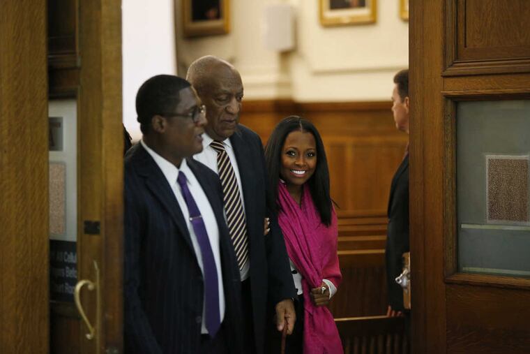 Actress Keshia Knight Pulliam, right, smiles as she walks out of the courtroom with Bill Cosby, center, inside the Montgomery County Courthouse in Norristown, PA on June 5, 2017. Cosby is accused sexual assault.