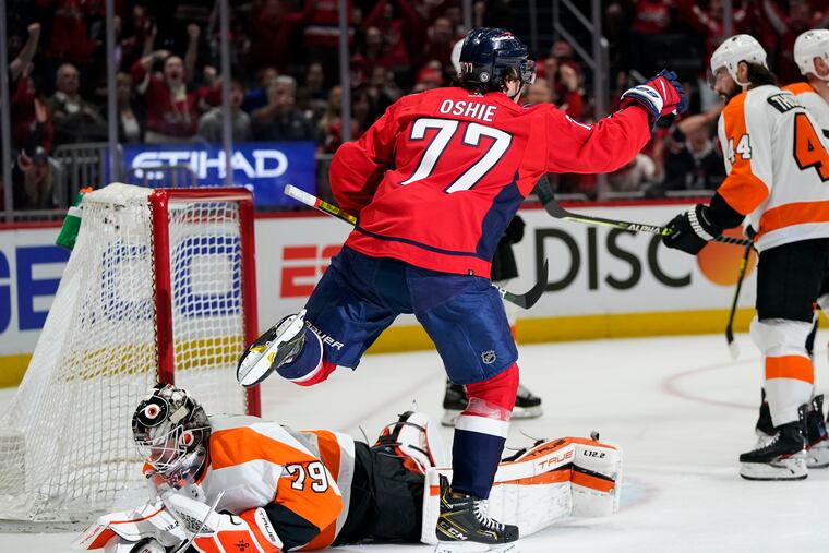 Capitals right winger T.J. Oshie celebrates his goal against Flyers goaltender Carter Hart during the first period.