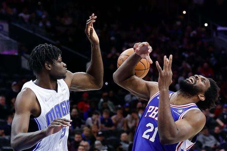 Sixers center Joel Embiid loses the basketball after getting fouled by Orlando Magic center Mo Bamba during the third quarter on Monday.