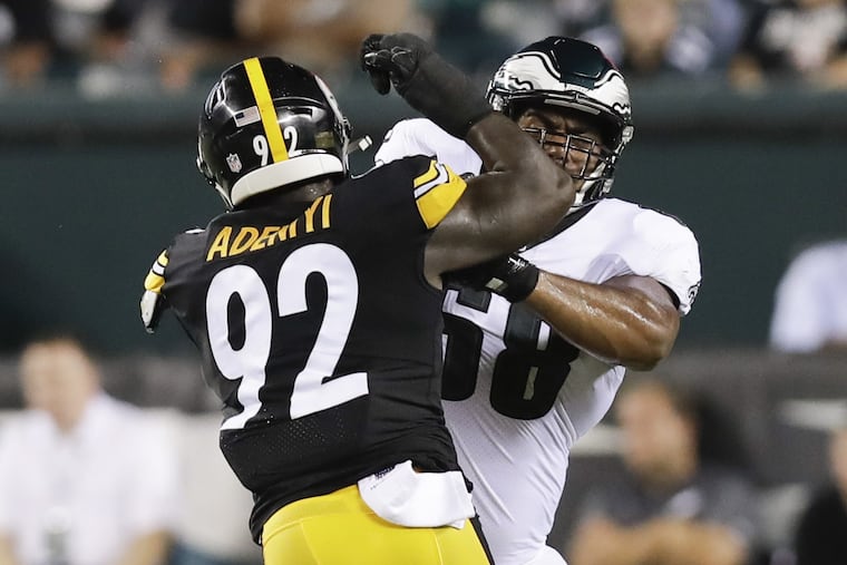 Jordan Mailata, right, blocking the Steelers' Olasunkanmi Adeniyi on Thursday.