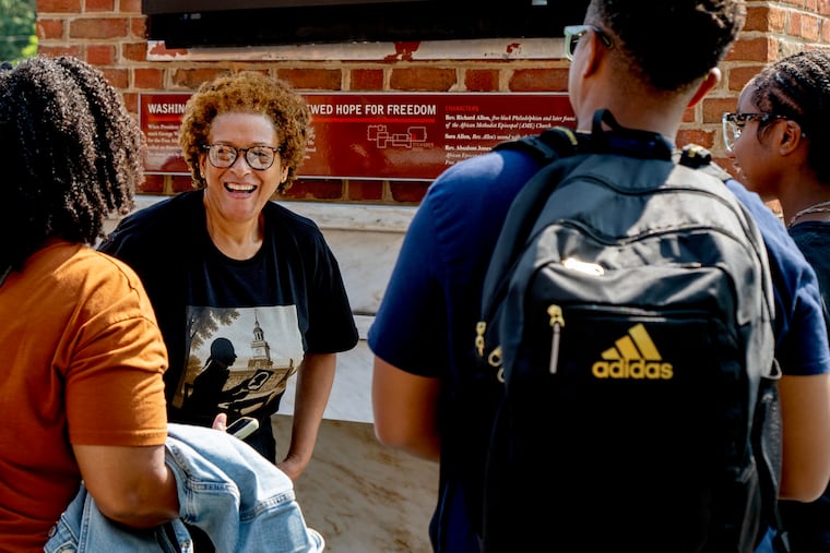 The author talks with tourists at the President's House at Independence National Historical Park on Monday, Aug. 4, 2025. Before the site opened over a decade ago, there was a fight, led mostly by Black activists, to center the site around the stories of the nine people President George Washington enslaved there. Now six of its exhibits — all referencing slavery — are in jeopardy under a Trump administration executive order.