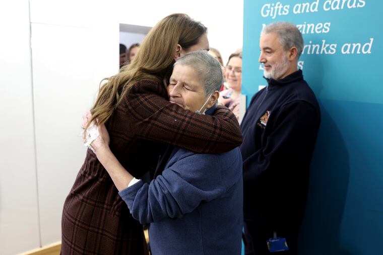 Britain's Princess Kate, left, hugs Rebecca Mendelhson during a visit on Tuesday to The Royal Marsden Hospital, where she received her cancer treatment, in London, England.