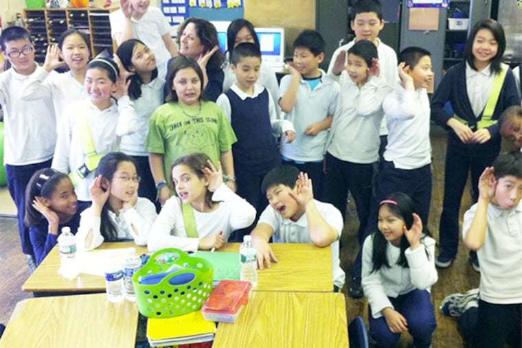 Fifth-grader teacher Joanna Bottaro (hiding in the back) and her students at the Gen. George McCall School are studying the art of listening and how it helps others feel emotionally connected and cared for.