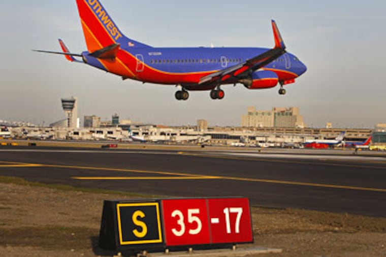 A Southwest jet lands on Runway 17-35 (the sign says 35-17 to tell pilots that taking off from this point would head them 350 degrees clockwise from due north). Now that 17-35 has been extended 1,040 feet, it can handle the Airbus A320s operated by US Airways. Before Feb. 12, only smaller craft could use it. (Michael S. Wirtz / Staff Photographer)