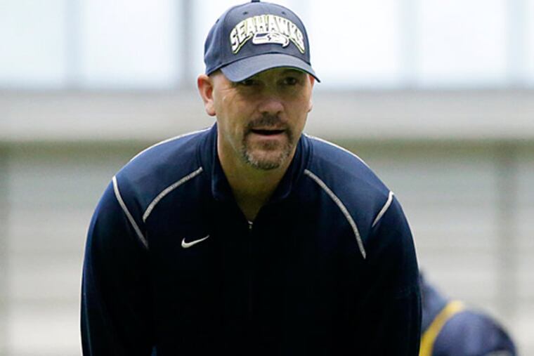 eattle Seahawks defensive coordinator Gus Bradley, left, stands with head coach Pete Carroll, right, on the field during NFL football practice, Thursday, Jan. 10, 2013, in Renton, Wash. Bradley is on the the list of possible candidates for the Philadelphia Eagles head coaching job to replace Andy Reid. (AP Photo/Ted S. Warren)