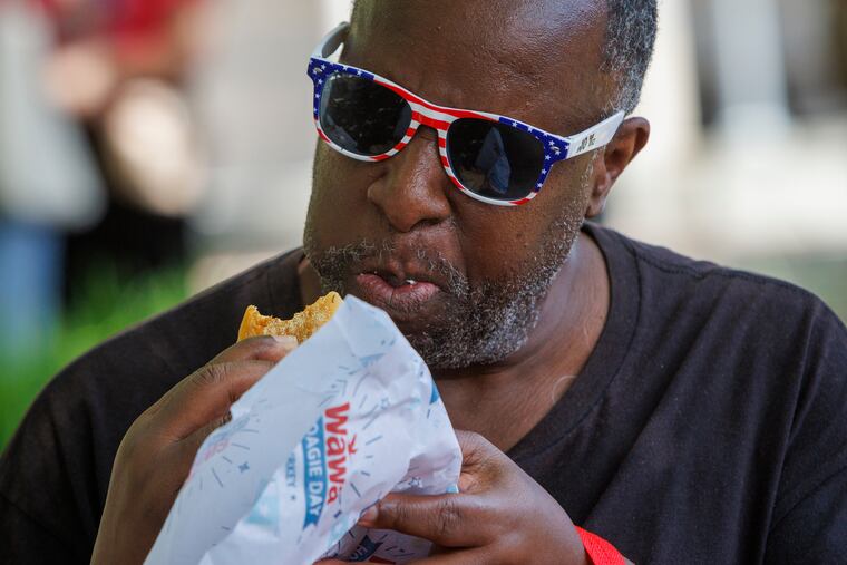 Michael Alfton of Philadelphia enjoys a free hoagie during Wawa Hoagie Day in 2024. He has been attending Hoagie Day for the past 10 years. This year's Hoagie Day is Thursday, June 26, starting at noon, outside the National Constitution Center.