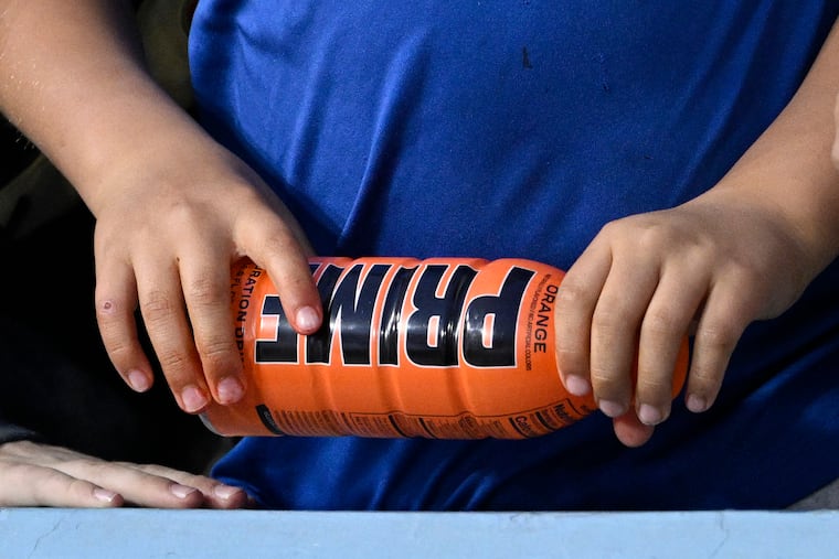 A child holds a PRIME hydration drink prior to a baseball game between the Los Angeles Dodgers and the Arizona Diamondbacks in 2023 in Los Angeles.