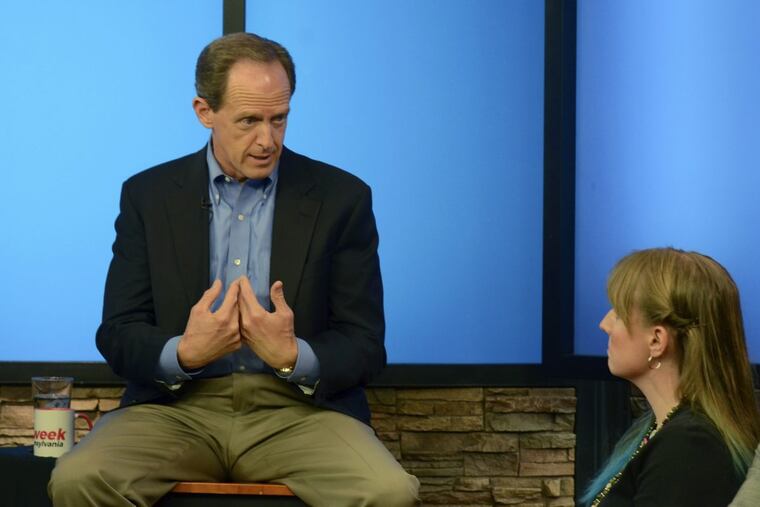 Pennsylvania’s U.S. Sen. Pat Toomey answers a question from Nancy Rohrbaugh, of Dillsburg, Pa., right, during an hour-long question-and-answer session in the studios of WHTM-TV, Wednesday, July 5, 2017 in Harrisburg, Pa. (AP Photo/Marc Levy)