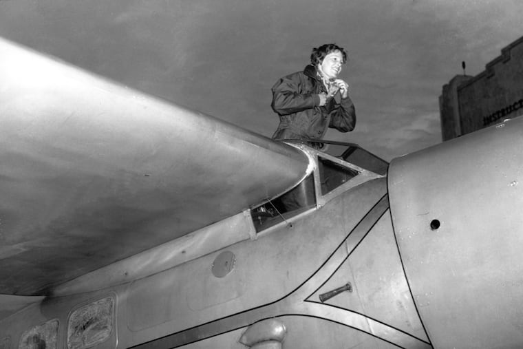 FILE - In this Jan. 13, 1935, file photo, American aviatrix Amelia Earhart climbs from the cockpit of her plane at Los Angeles, Calif., after a flight from Oakland to visit her mother. Robert Ballard, who discovered the Titanic, and a National Geographic expedition will search for Earhart's plane in August 2019 near a Pacific Ocean atoll named Nikumaroro, part of the Phoenix Islands. (AP Photo, File)
