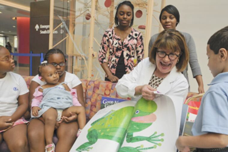 Dr. Trude Haecker, founder of the Reach out and Read program, reads to children in the lobby of Children's Hospital of Philadelphia. (Ron Tarver / Staff Photographer)