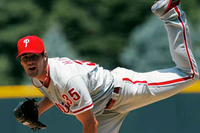 Cole Hamels scattered six hits and had seven strikeouts in his first win in three career outings at Coors Field. (David Zalubowsk/AP)