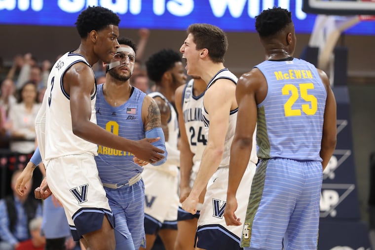 Brandon Slater, left, and Collin Gillespie of Villanova celebrate after forcing Markus Howard of Marquette into a turnover during the first half.