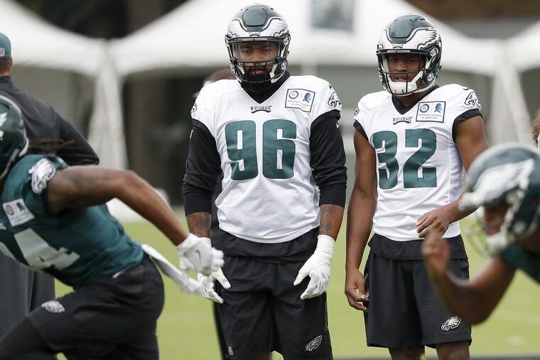 Eagles’ rookies Derek Barnett, left, and Rasul Douglas, right, watch during the Eagles 2017 training camp at the NovaCare complex in Philadelphia, PA on July 26, 2017. DAVID MAIALETTI / Staff Photographer
