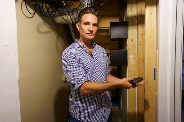 Robert Brothers holds his gun, which he keeps in a safe inside a locked shed at his home in Bala Cynwyd, PA.