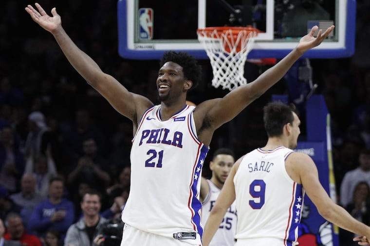 Sixers’ center Joel Embiid reacts to the crowd following his dunk during the second half of the SIxers’ win over the Timberwolves on Saturday.