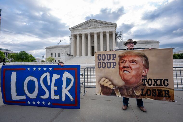 Activist Stephen Parlato of Boulder, Colo., right, joins other protesters outside the Supreme Court as the justices prepare to hear arguments over whether Donald Trump is immune from prosecution in a case charging him with plotting to overturn the results of the 2020 presidential election, on Capitol Hill in Washington on Thursday.