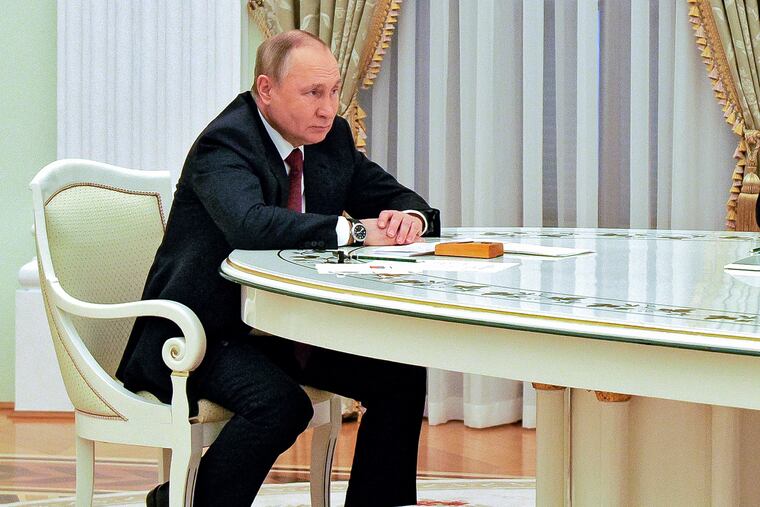 Russian President Vladimir Putin listens to Hungary's Prime Minister Viktor Orban during their meeting in the Kremlin in Moscow.