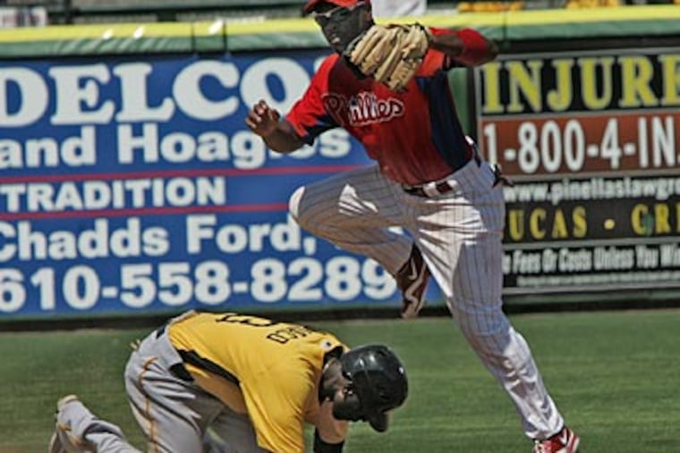 Jimmy Rollins gets airborne as he puts out Pirates Pedro Ciriaco in the fifth inning. (David M Warren / Staff Photographer)
