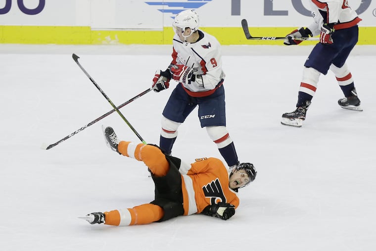 Flyers James van Riemsdyk lands hard after colliding with Caps # 9 Dmitry Orlov in the 3rd period of the Washington Capitals at Philadelphia Flyers NHL game at the Wells Fargo Center in Phila., Pa. on March 14, 2019.