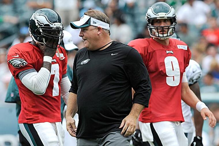 Eagles coach Chip Kelly calls out a play as Michael Vick and Nick Foles line up. (Michael Perez/AP)