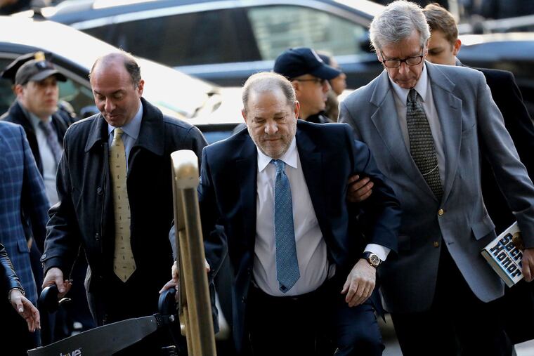 Harvey Weinstein (center), former co-chairman of the Weinstein Co., arrives at State Supreme Court in New York on Feb. 24, 2020. He was convicted that day of third-degree rape and criminal sexual act in the first degree.