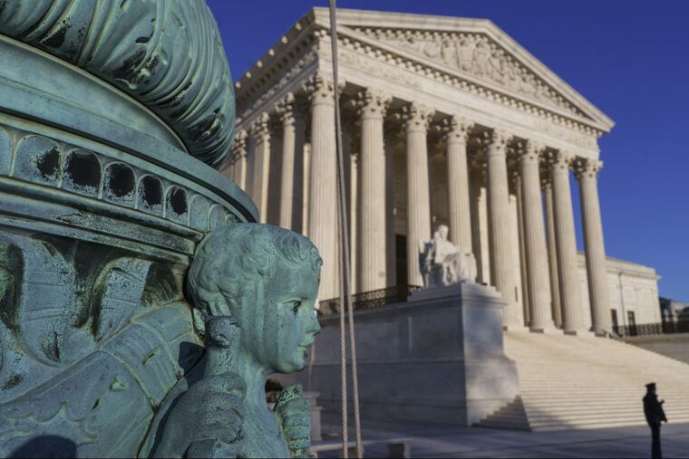 The Supreme Court is seen in Washington, April 20, 2018. The Supreme Court says employers can prohibit their workers from banding together to complain about pay and conditions in the workplace.