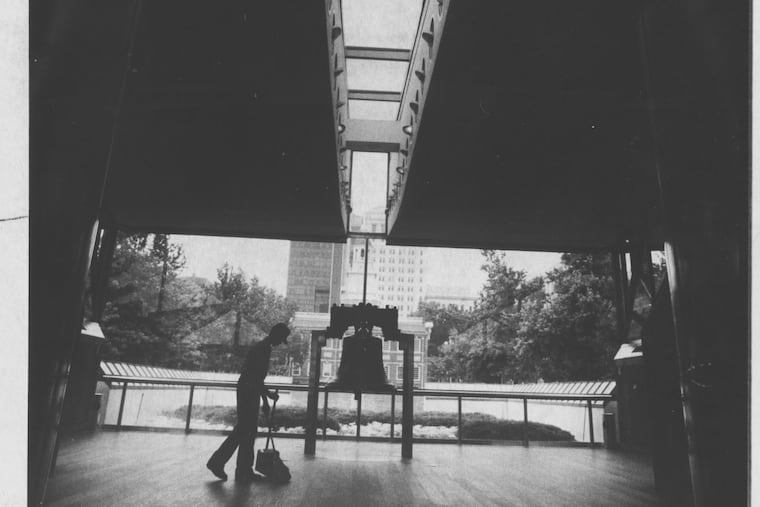 National Parks employee Michael Coleman sweeps next to Liberty Bell at the original Liberty Bell pavilion.