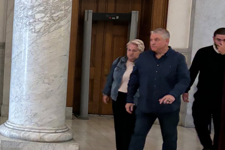 Linda Mansi leaves the Montgomery County Courthouse with her husband and on son on Thursday. Mansi was sentenced to 11 1/2 to 23 months in county jail for stealing nearly $1 million from a furniture business she worked for.