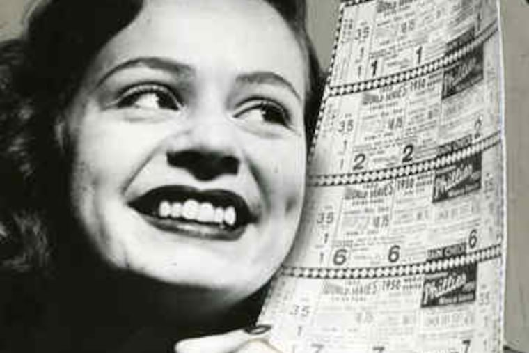 Mary Alice Sullivan, of the Phillies office staff, displays 1950 World Series tickets.