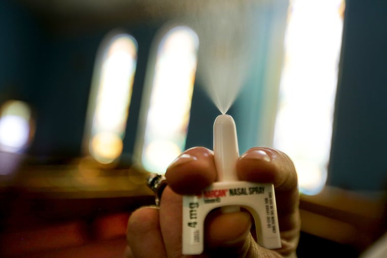 Elvis Rosado demonstrates with one of the naloxone nasal sprays at Prevention Point in Philadelphia.
