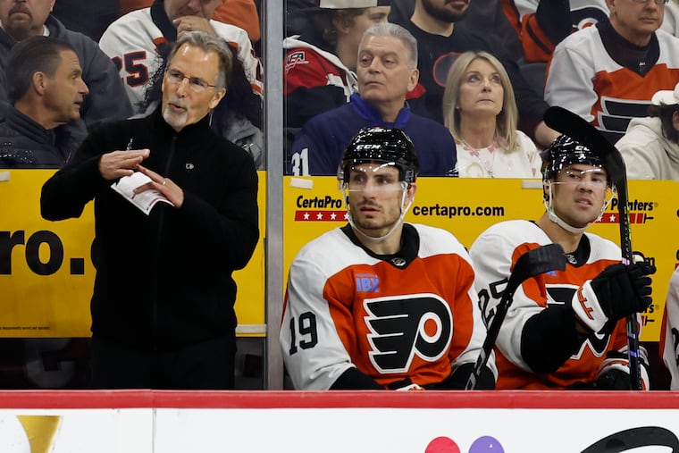 Flyers head coach John Tortorella calls for a timeout with right wing Garnet Hathaway and center Ryan Poehling against the New York Rangers on Feb. 24.
