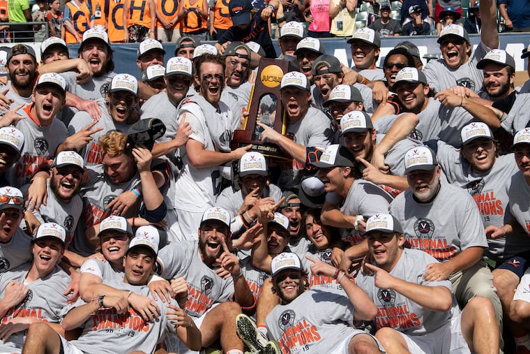 Virginia celebrates with the national championship trophy on Monday at the Linc.