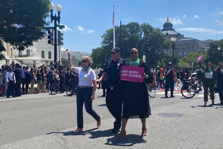 U.S. Rep. Madeleine Dean (D., Pa.), left, is arrested with other members of congress and abortion rights protesters in front of the U.S. Supreme Court on Tuesday in Washington, D.C.