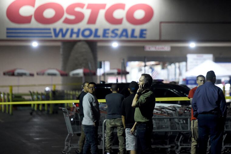 A Costco employee talks on the phone following a shooting within the wholesale outlet in Corona, Calif., Friday, June 14, 2019. A gunman opened fire inside the store during an argument, killing a man, wounding two other people and sparking a stampede of terrified shoppers before he was taken into custody, police said. The man involved in the argument was killed and two other people were wounded, Corona police Lt. Jeff Edwards said. (Will Lester / Inland Valley Daily Bulletin / SCNG via AP)