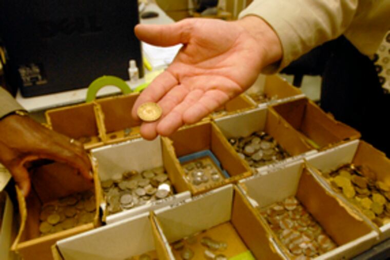 This transit token from more than 30 years ago is among the foreign coins, damaged money and other objects found.