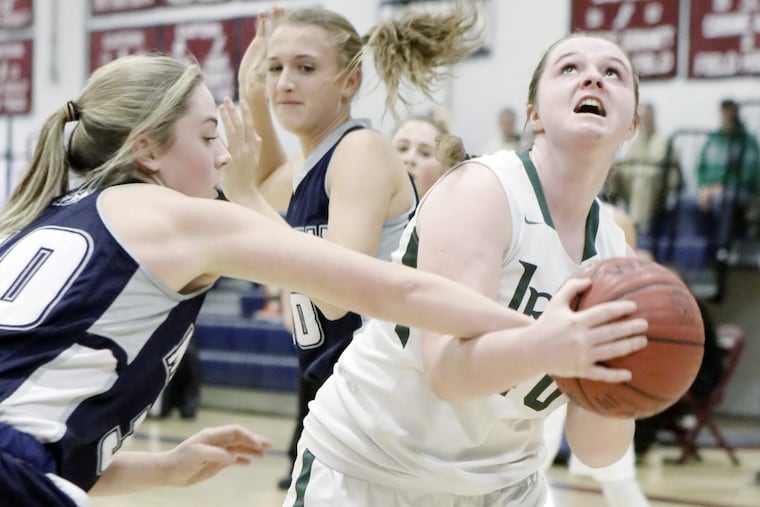 Manasquan’s Faith Masonius tries to grab the ball from Camden Catholic’s Kate Deutsch in a game last season.