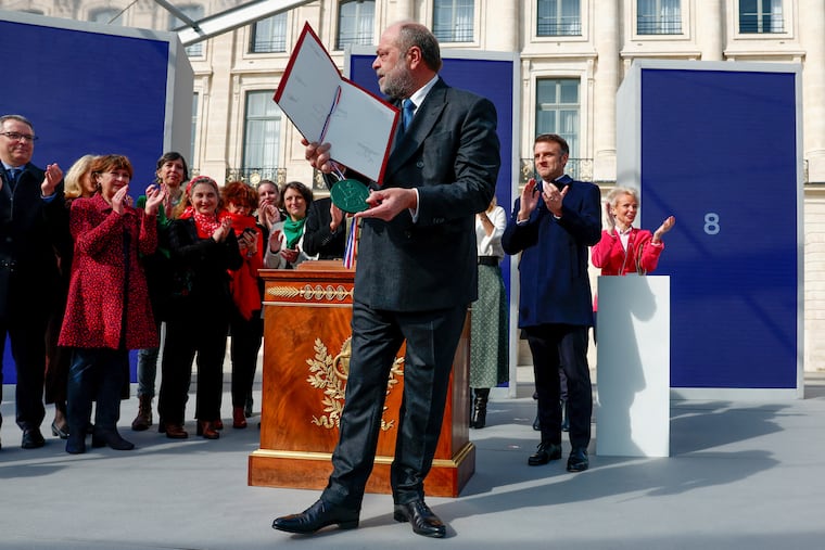 Justice Minister Eric Dupond-Moretti and French President Emmanuel Macron, background right, attend a ceremony to seal the right to abortion in the French constitution at the Place Vendome in Paris on Friday, March 8, 2024.