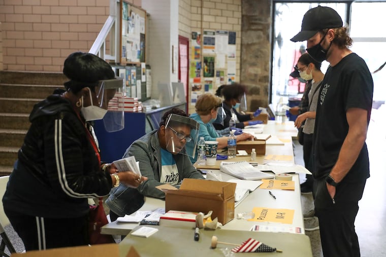Voters sign in at the Marian Anderson Recreation Center on Election Day in Philadelphia on Tuesday, June 2, 2020. There were fewer polling locations across the city for people to vote from on Pennsylvania's primary election day due to the coronavirus pandemic.