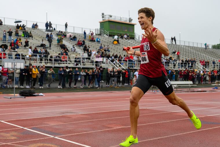 St. Joe's senior Owen Moelter crosses the finish line to win the men's 4x800 relay at the Atlantic 10 championships.